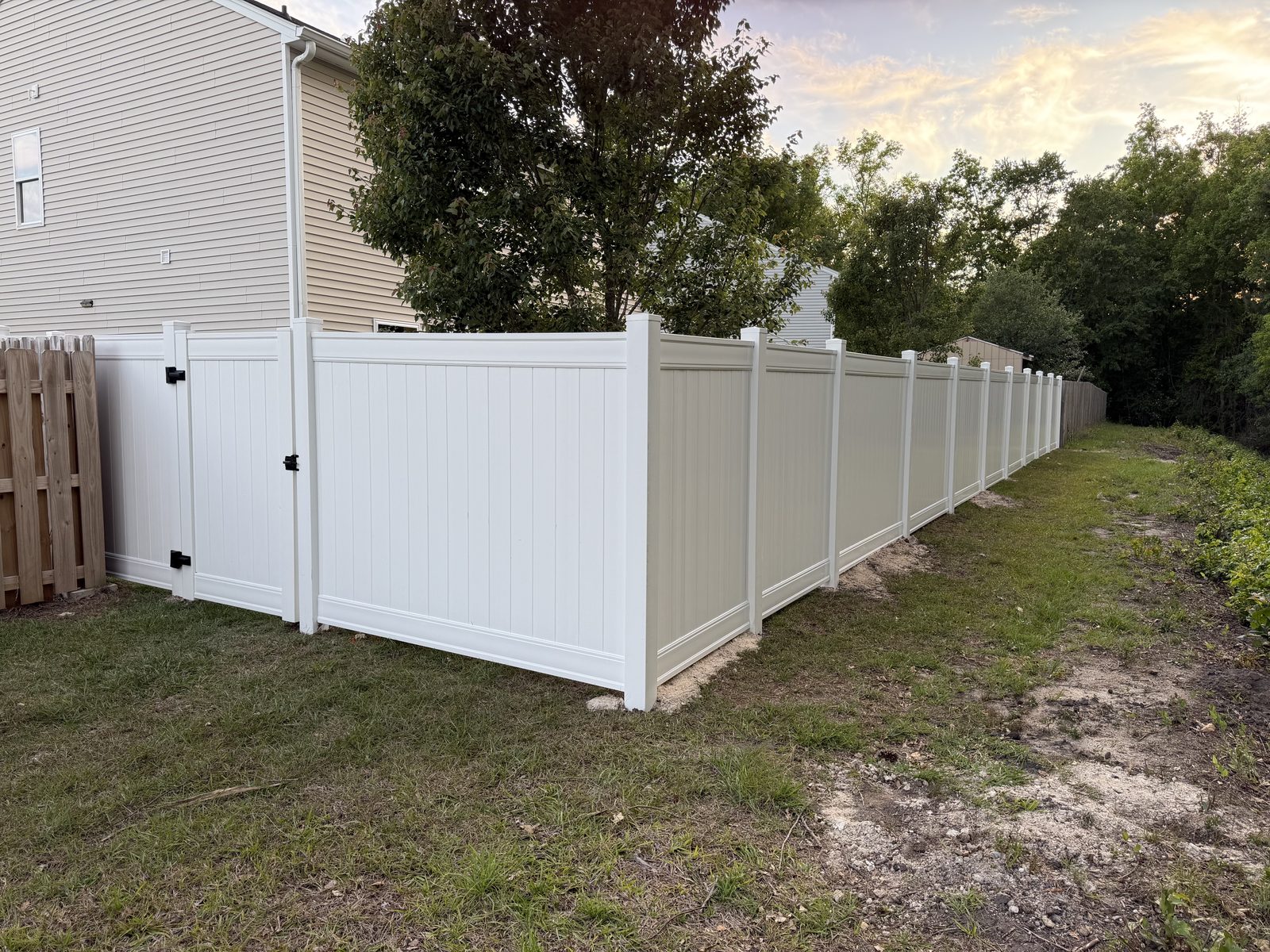 White & tan vinyl privacy fence